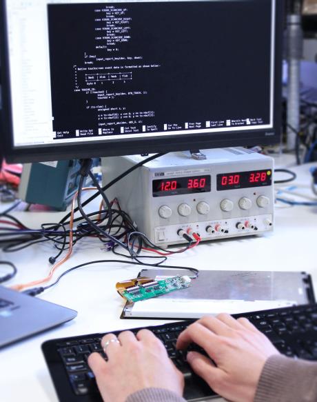 engineer updating firmware settings of display controller